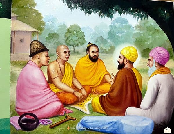 Guru Nanak Dev Ji seated in conversation with holy men of different paths beneath a tree